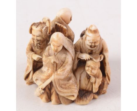 A Japanese ivory netsuke carved as a group of figures representing the six famous poets (Rokkasen), three nobles, two priests