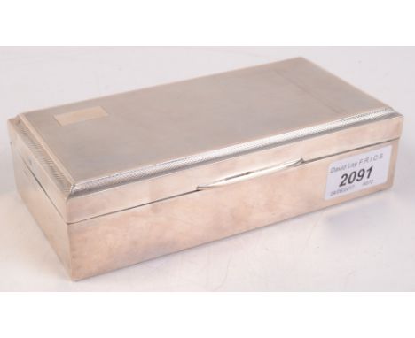 An engine turned silver cigarette box.