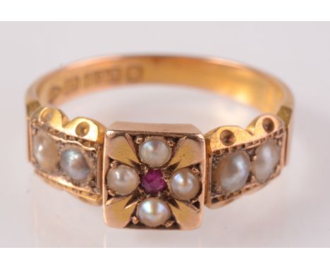 A 15ct gold Victorian ring with a pearl and ruby Maltese cross flanked by pearl shoulders, Chester 1885.