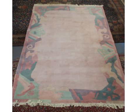 A Tibetan hand made wool carpet, the rose field within a polychrome border, 300 x 200cm.