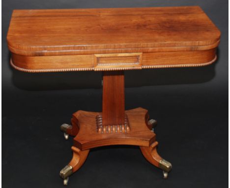 A Regency rosewood veneered fold top card table, the frieze with applied half round bobbin turned mouldings on plain tapering