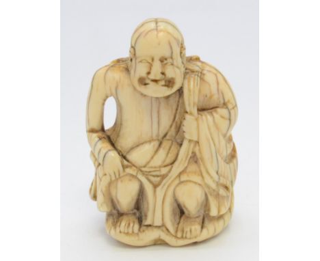 A Japanese ivory netsuke of a seated Rakan, holding his robes at his shoulder and knee, a gourd hanging over his left shoulde