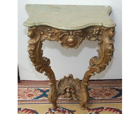 An 18th century carved and gilt small console table with marble top, in Louis XV style.   Condition report:  Top is modern, t