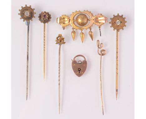 Gold and other stick pins, a gold padlock clasp and a gilt brooch. 