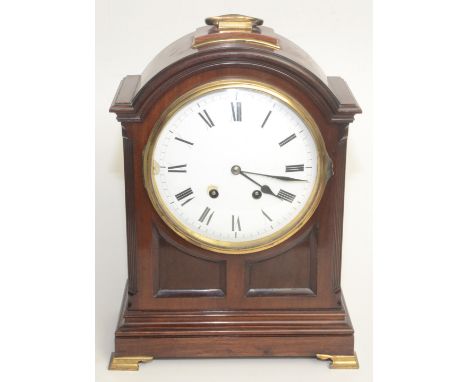 An Edwardian mahogany bracket clock, the circular 19.5cm dial flanked by chamfered fluted corners, on brass bracket feet, mov