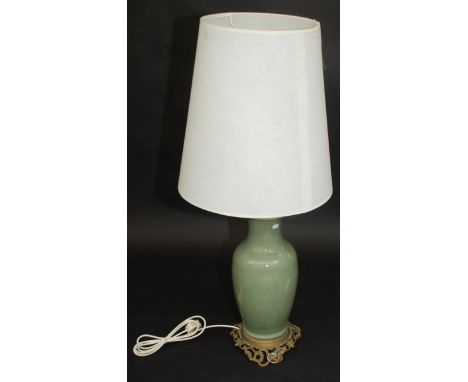 A Chinese celadon glazed vase, converted to a table lamp, mounted on a pierced gilt metal base, height of vase 44cm. 
