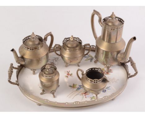 A WMF four piece tea service in the manner of the Secessionist Movement, the matching oval tray with a floral ceramic centre.