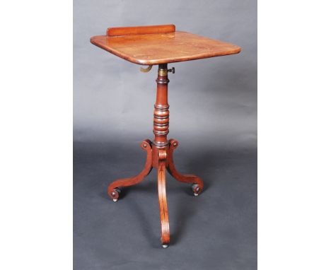A Regency mahogany music stand with rectangular top on adjustable brass sector with removable fiddle, the telescopic pedestal