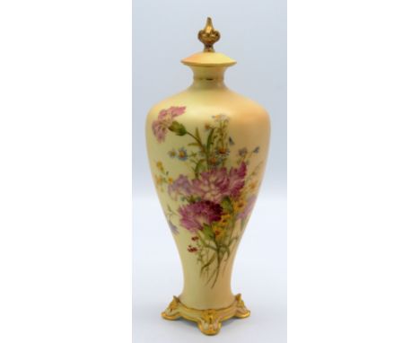 A Royal Worcester blush porcelain vase, the polychrome decoration of carnations and foliage, on four gilt decorated shell fee