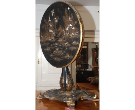 An early Victorian papier mache chinoiserie black ground, fold top pedestal table, inlaid with mother of pearl and heightened