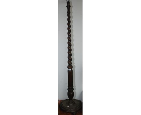 An oak tapering, spiral turned standard lamp.