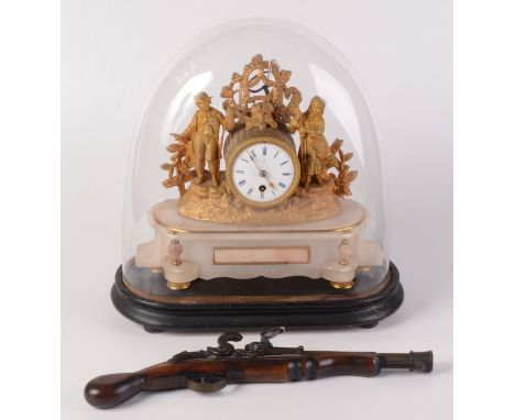 A French gilt metal mantel clock, the circular enamel dial surmounted by a figure of a noble beneath a glass dome on ebonised