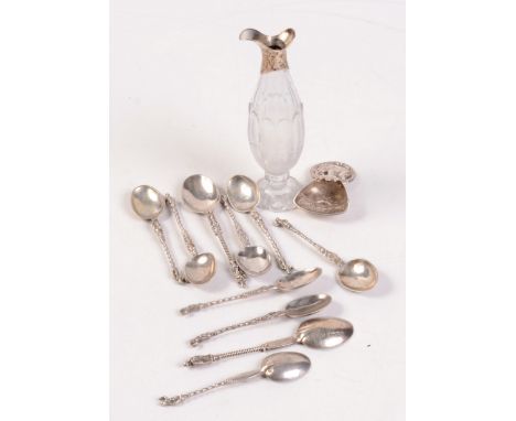 A Dutch silver caddy spoon, ten continental apostle spoons and a Georgian silver mounted condiment bottle. 