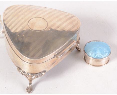 A triangular section, engine turned silver jewel box and an enamelled silver small compact. 