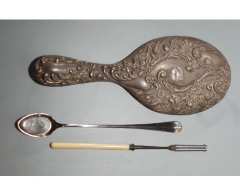 A silver Victorian pickle fork with ivory handle, a silver mounted toilet mirror and a silver plated spoon. 