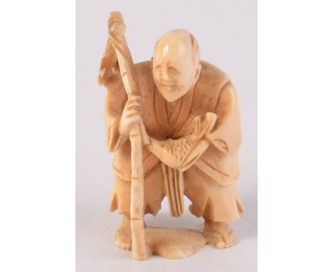 A Chinese carved ivory netsuke, an elderly gentleman carrying a bamboo cane with fish, incised signature to base, height 5.5c