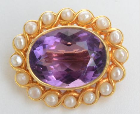 A gold amethyst and pearl oval brooch.
