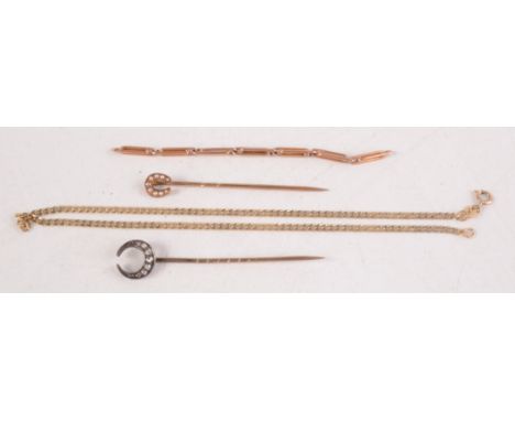 A diamond set stick pin, a pearl horseshoe stick pin and two pieces of gold chain. 