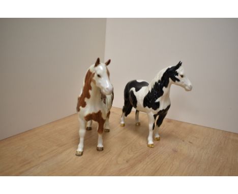 Two Beswick Pottery Pinto Ponies, comprising Skewbald first version and Piebald second version, number 1373 both designed by 