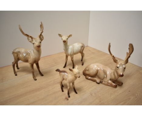 A Beswick Pottery deer family, comprising Stag standing number 981, Stag lying number 954, Doe number 999a and fawn number 10