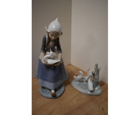 A Lladro porcelain figurine, a young Dutch girl with duck or goose, printed marks to underside 26cm, sold together with a Nao