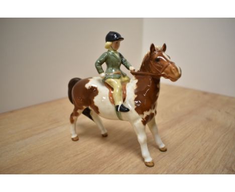 A Beswick Pottery 'Girl on Skewbald Pony' model number 1499, designed by Arthur Gredington, looking forward with green jacket