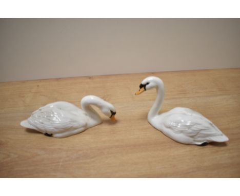 Two Beswick Pottery swan studies, model number 1684 (head up) ad 1685 (head down) both designed by Arthur Gredington in white