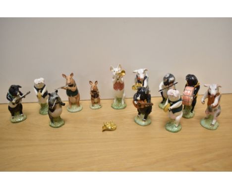 A collection of twelve Beswick Pottery 'Pig Promonade' anthropomorphic band members, some marked as Sinclairs special edition