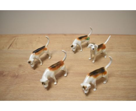 A group of five Beswick Pottery Foxhounds model numbers 2264 (4) second version designed by Graham Tongue in white, tan and b