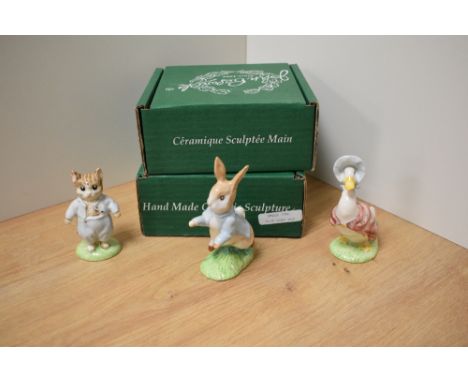 A group of three Beswick Pottery Beatrix Potter figures, comprising Tom Kitten, Peter Rabbit and Jemima Puddleduck, each with