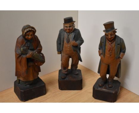 A group of three carved and hand-decorated pine Dickens figures, Mrs Gamp, Captain Cuttle and Artful Dodger, each with deplet