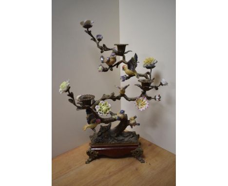 A large and attractive cast gilt metal and porcelain three sconce candlestick, formed as a sinuous tree with ceramic blossoms