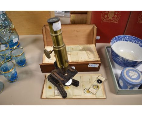 An early 20th century 'Improved Household Microscope' having rack and pinion focus from the right side, objective of typical 
