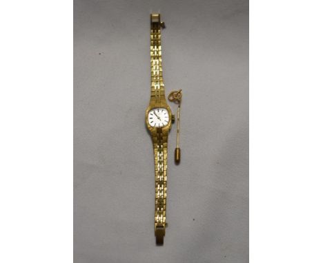 A ladies Rotary wristwatch and a gold coloured pin brooch in the form of a knot