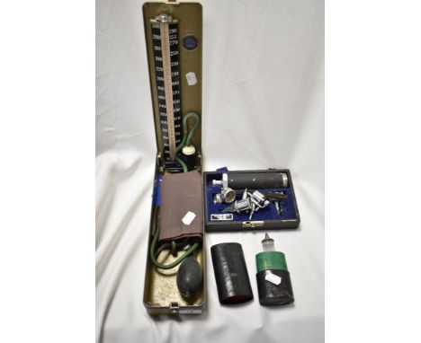 A vintage Accoson Dekamet Mk2 mercury Sphygmomanometer, a cased Edwards Surgical Supplies diagnostic set, and a glass medical