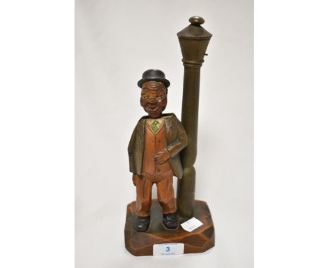 A continental novelty corkscrew and bottle opener, in the form of a smoking gentleman beside a lamp post, 22cm tall