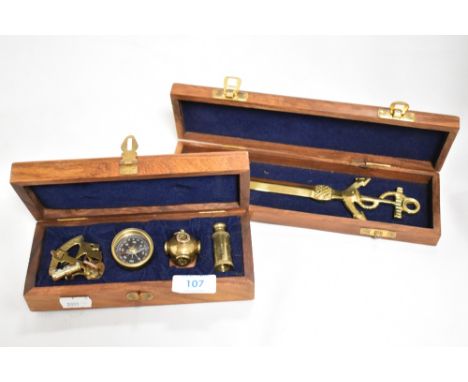 A group of four modern brass miniature nautical themed items, sextand, compass, divers helmet and telescope, all housed in a 