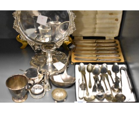 A group of mixed silver plated wares, salver, ladle, cup, chamber stick, spoons condiments etc