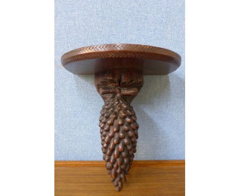 A late 19th/early 20th Century Black Forest carved softwood wall bracket