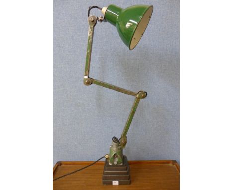 An industrial anglepoise lamp on cast iron base