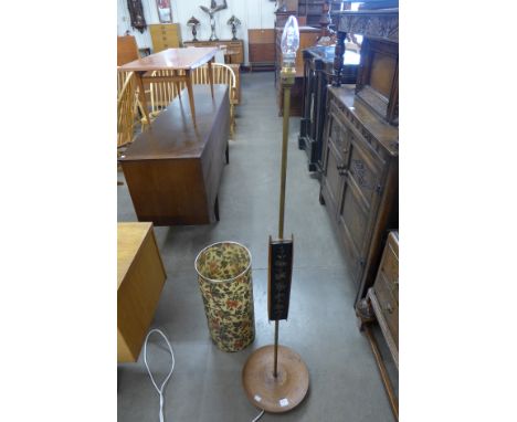 A teak standard lamp and waste paper bin