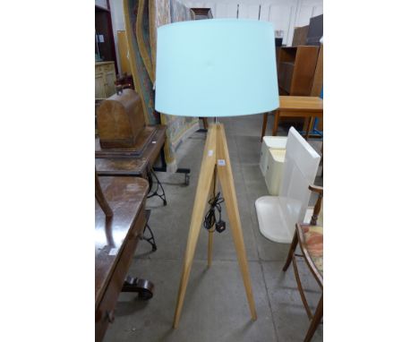 A tripod standard lamp