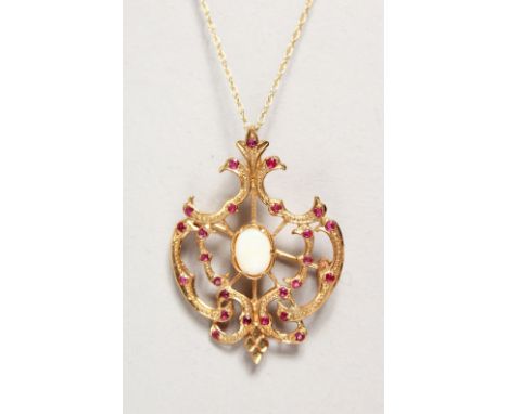 A 9CT GOLD OPAL AND RUBY PENDANT BROOCH on a chain.