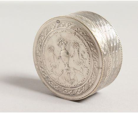 FRAINIER.&nbsp;A FRENCH SILVER CIRCULAR ENGINE TURNED BOX AND COVER,the top with urns and flowers. 2ins diameter.