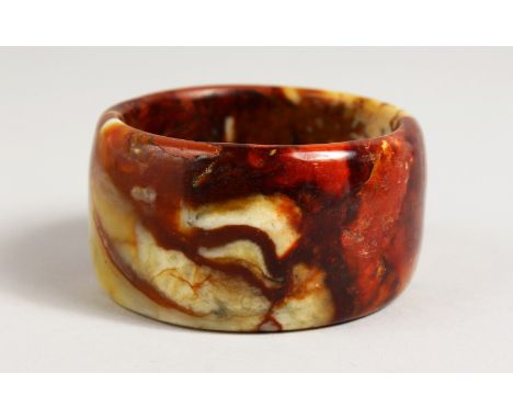 A WIDE CHINESE JADE BANGLE. 1.75ins deep x 3ins wide.