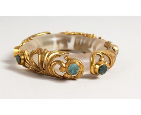 A RARE CRYSTAL AND GILT BANGLE set with eight hardstones. 4ins diameter.