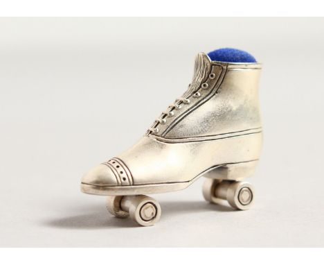 A CAST SILVER NOVELTY ROLLER SKATE PIN CUSHION.