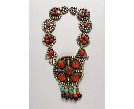 A LARGE ROMAN TYPE CORAL, ENAMEL AND SILVER NECKLACE set with a large circular pendant, 4ins diameter, hung from thirteen var