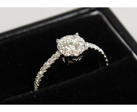 A GOOD 9CT GOLD DIAMOND RING WITH DIAMOND SHOULDERS.