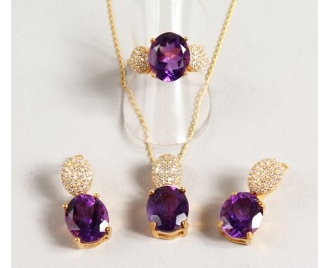 A SILVER AND GOLD PLATED THREE PIECE AMETHYST SET, pendant, earrings and ring.